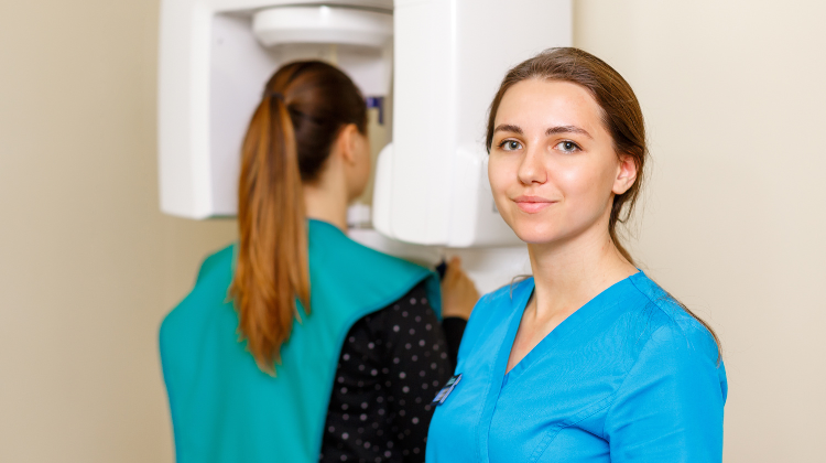 Dental hygienist at X-ray machine